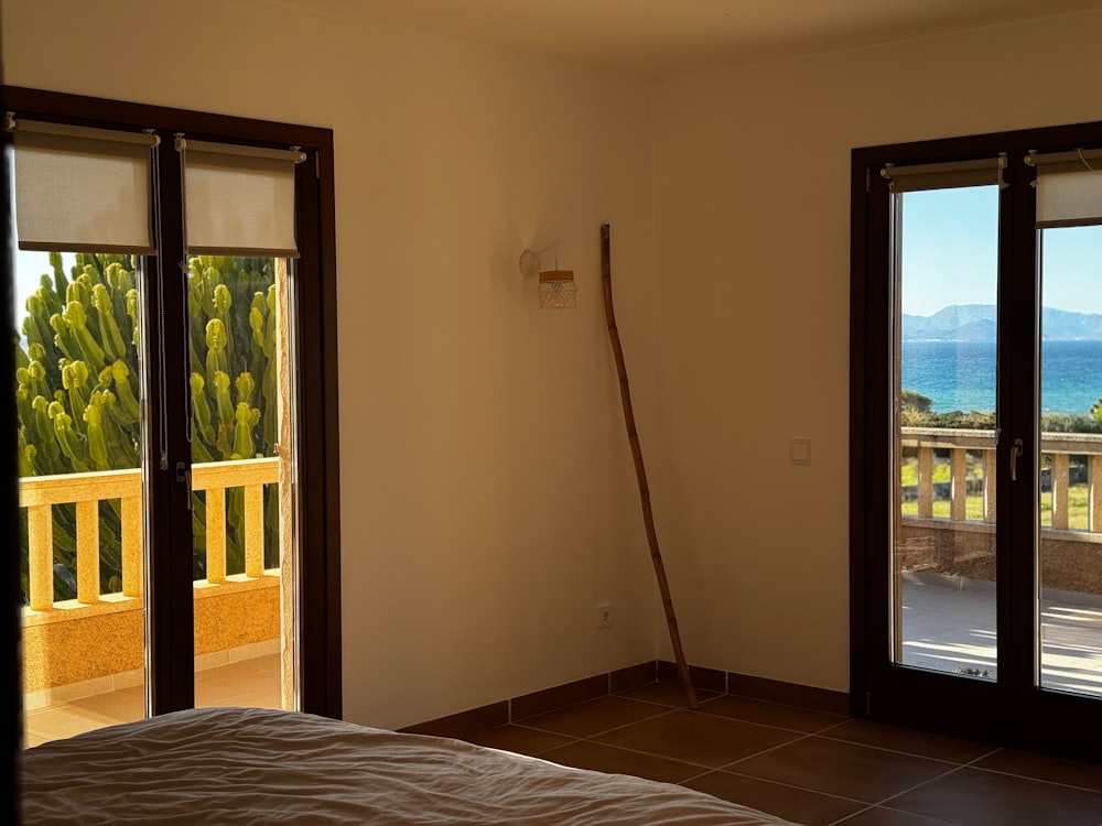 a bedroom with sliding glass doors leading to a balcony