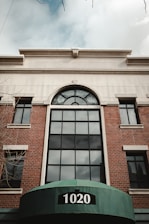 a large brick building with a green awning