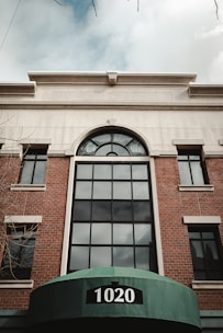 a large brick building with a green awning