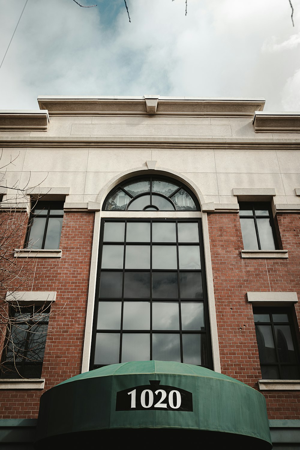 a large brick building with a green awning