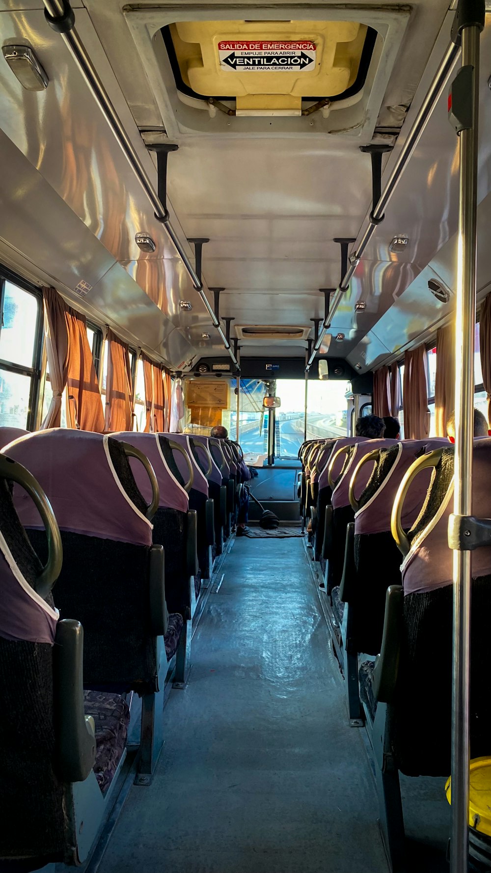 the inside of a bus with empty seats