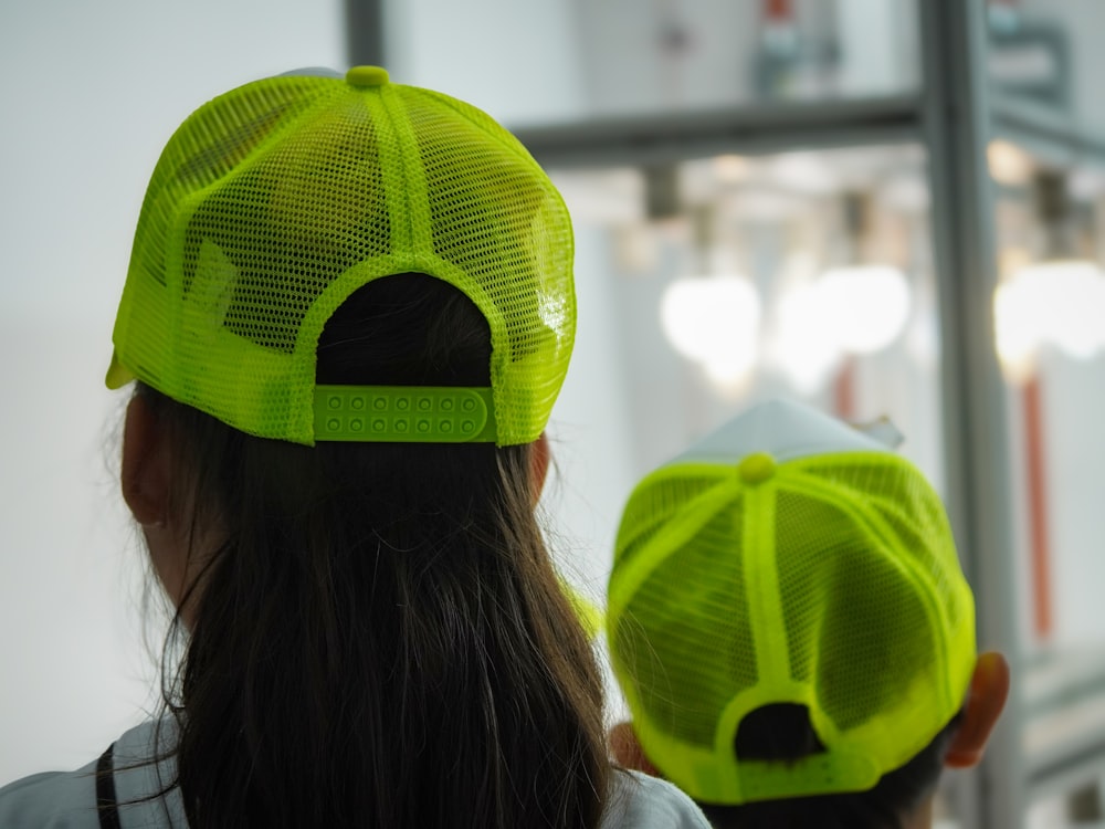 a woman wearing a neon green mesh hat
