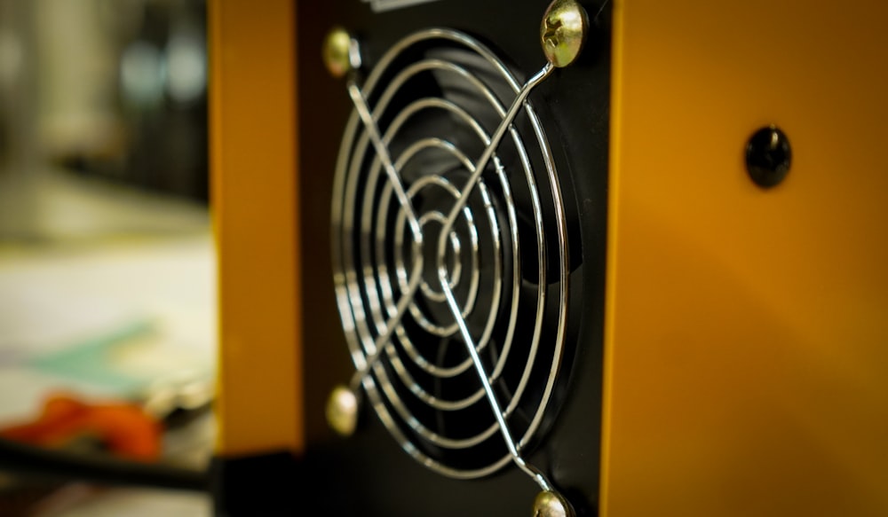 a close up of a yellow and black speaker