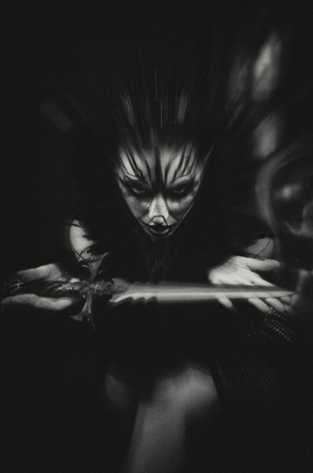 a black and white photo of a woman holding a laptop