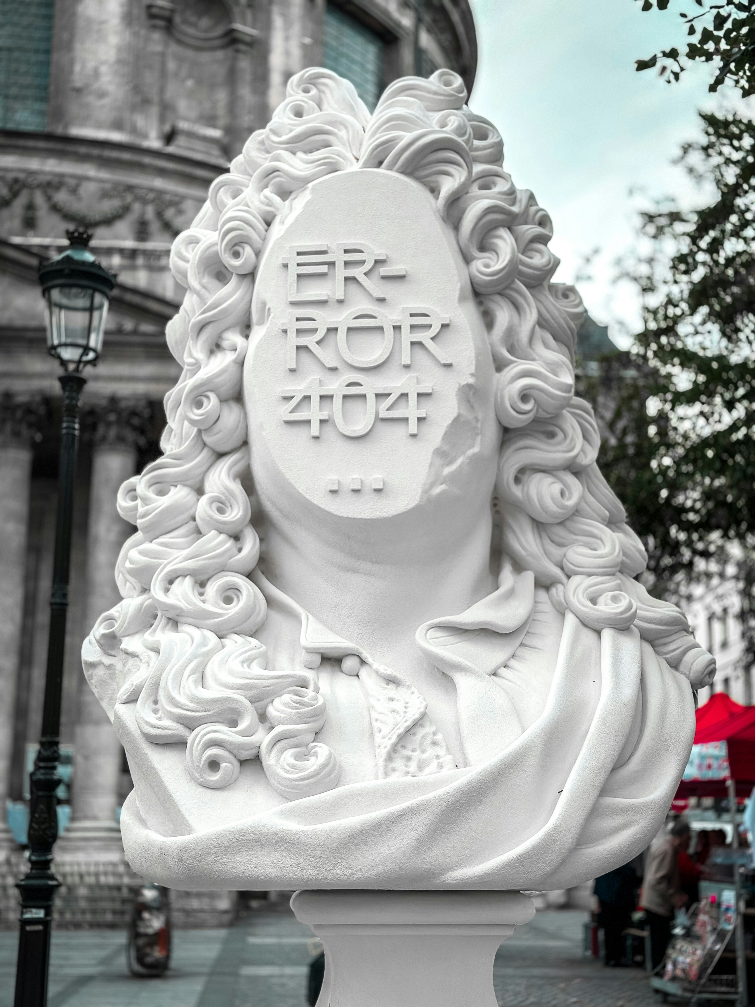 a white statue of a woman with curly hair