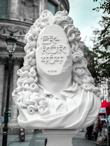 a white statue of a woman with curly hair