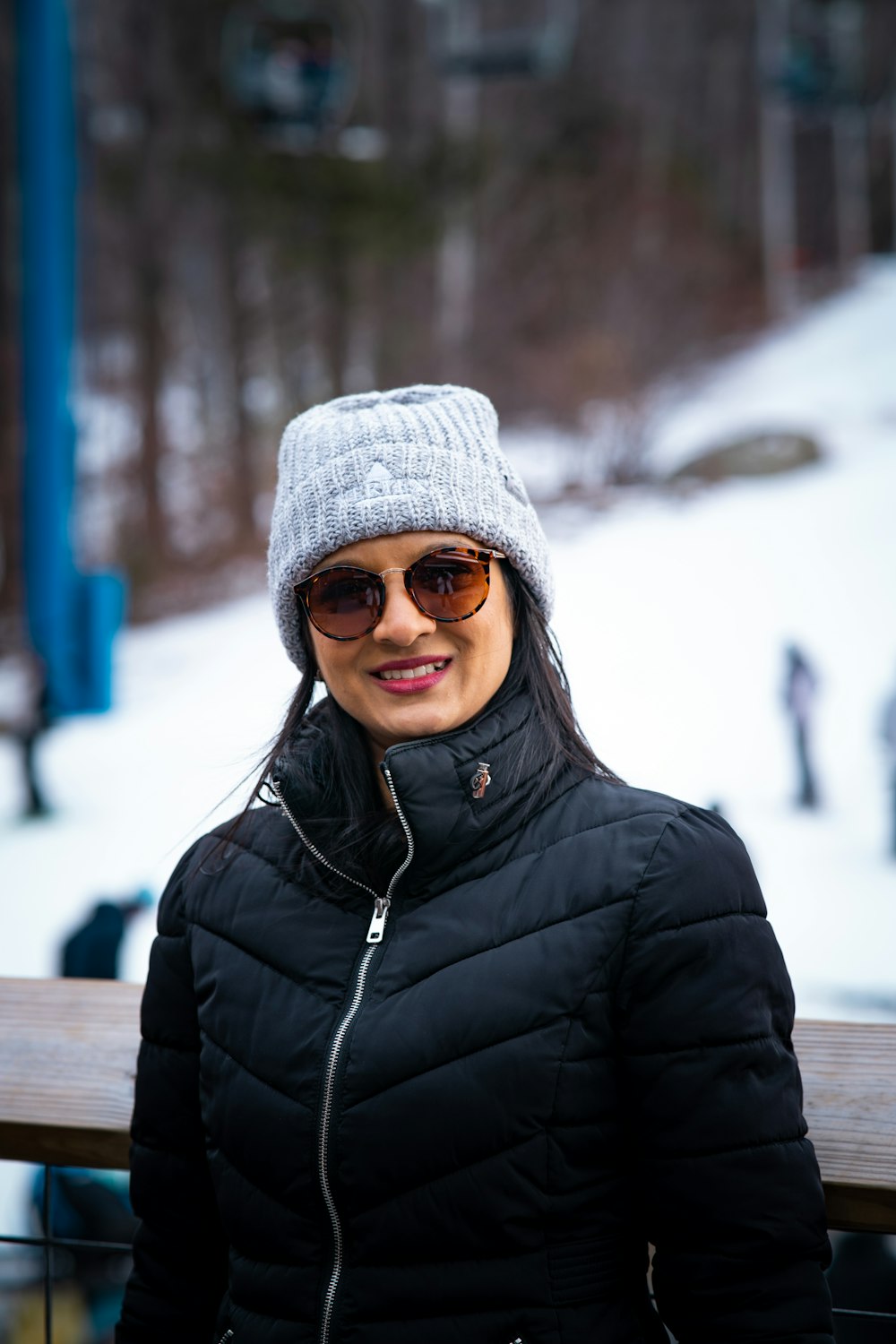 a woman in a black jacket and a gray hat