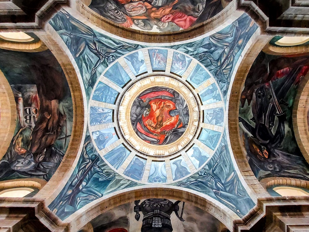 the ceiling of a building with paintings on it