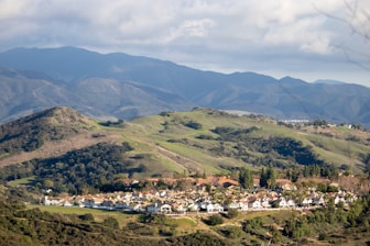 a scenic view of a small town in the mountains