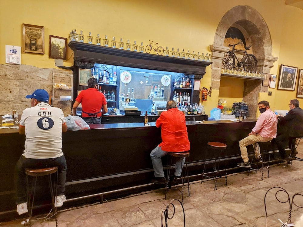 a group of people sitting at a bar