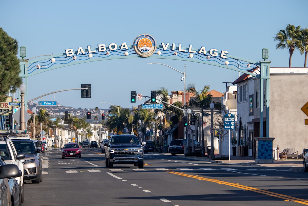 a street with cars driving under a street sign