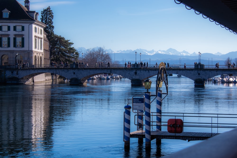 a bridge over a body of water next to a building