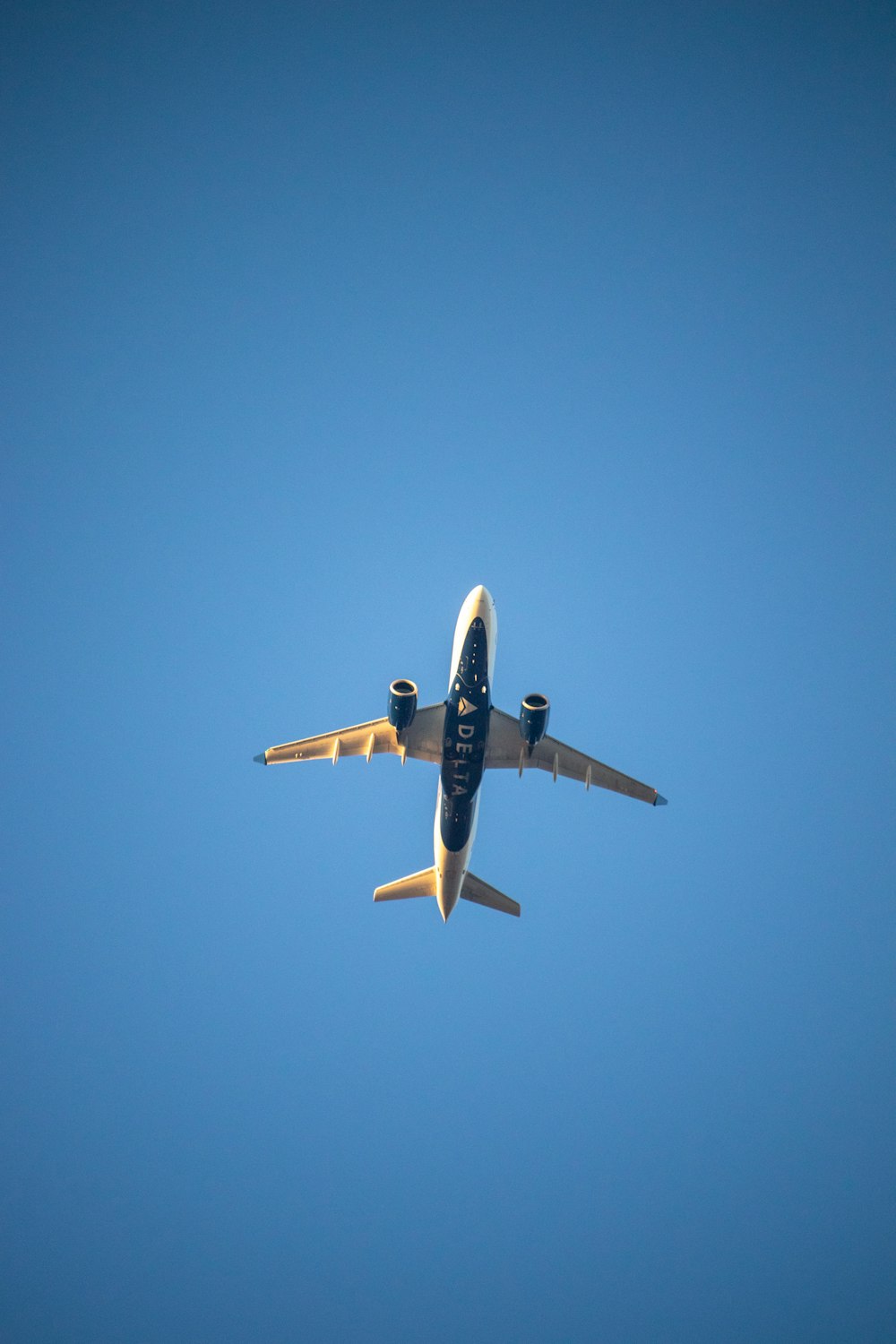 a large jetliner flying through a blue sky