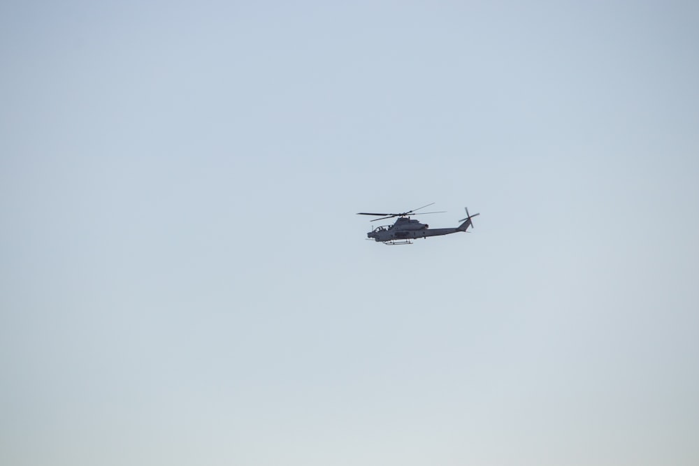 a helicopter flying in the sky on a clear day