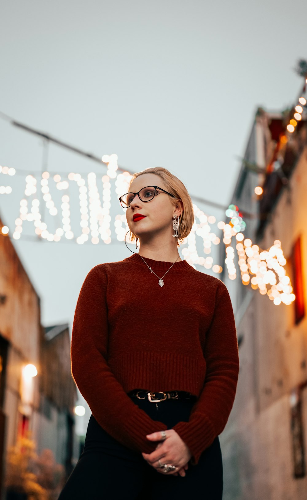 a woman in a red sweater and black pants