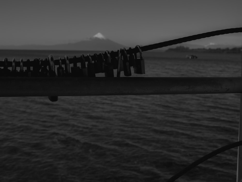 a black and white photo of a boat with a mountain in the background