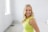 a woman in a yellow dress posing for a picture