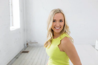 a woman in a yellow dress posing for a picture