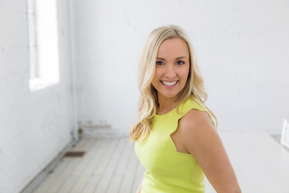 a woman in a yellow dress posing for a picture