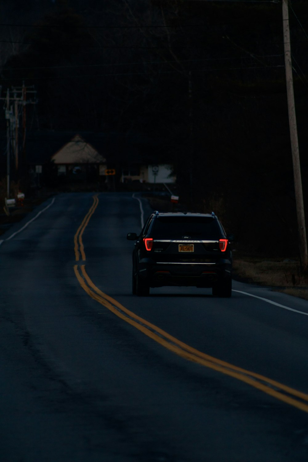 a car driving down a road at night