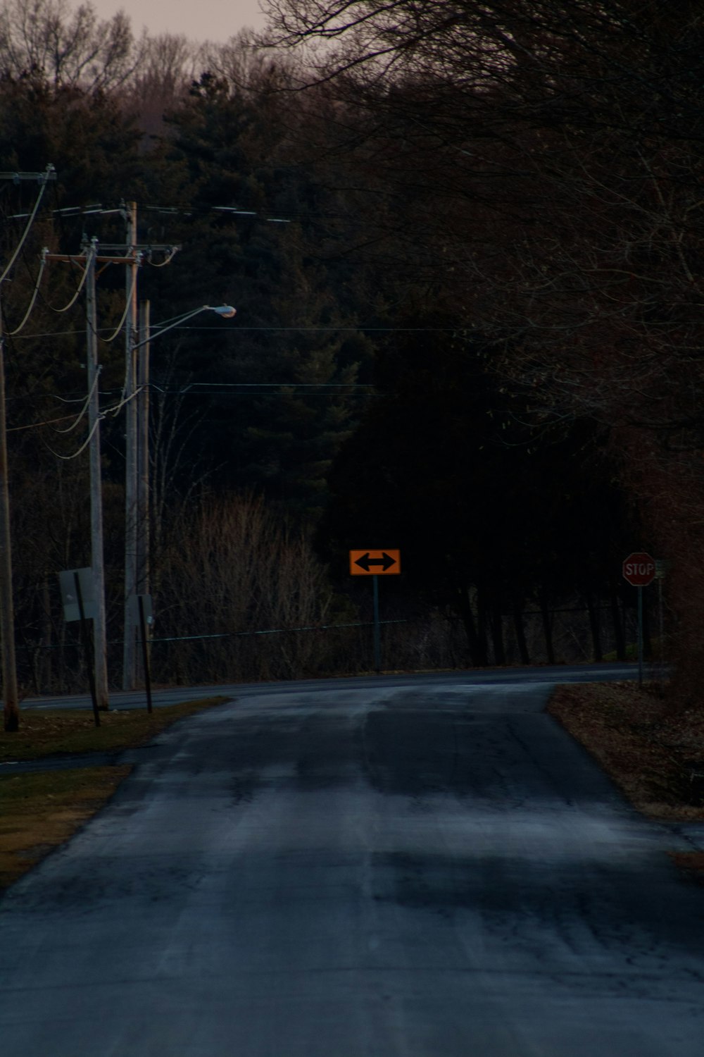 a road with a yellow sign on the side of it