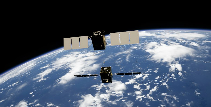 Mission control engineers monitoring screens of orbital telemetry data