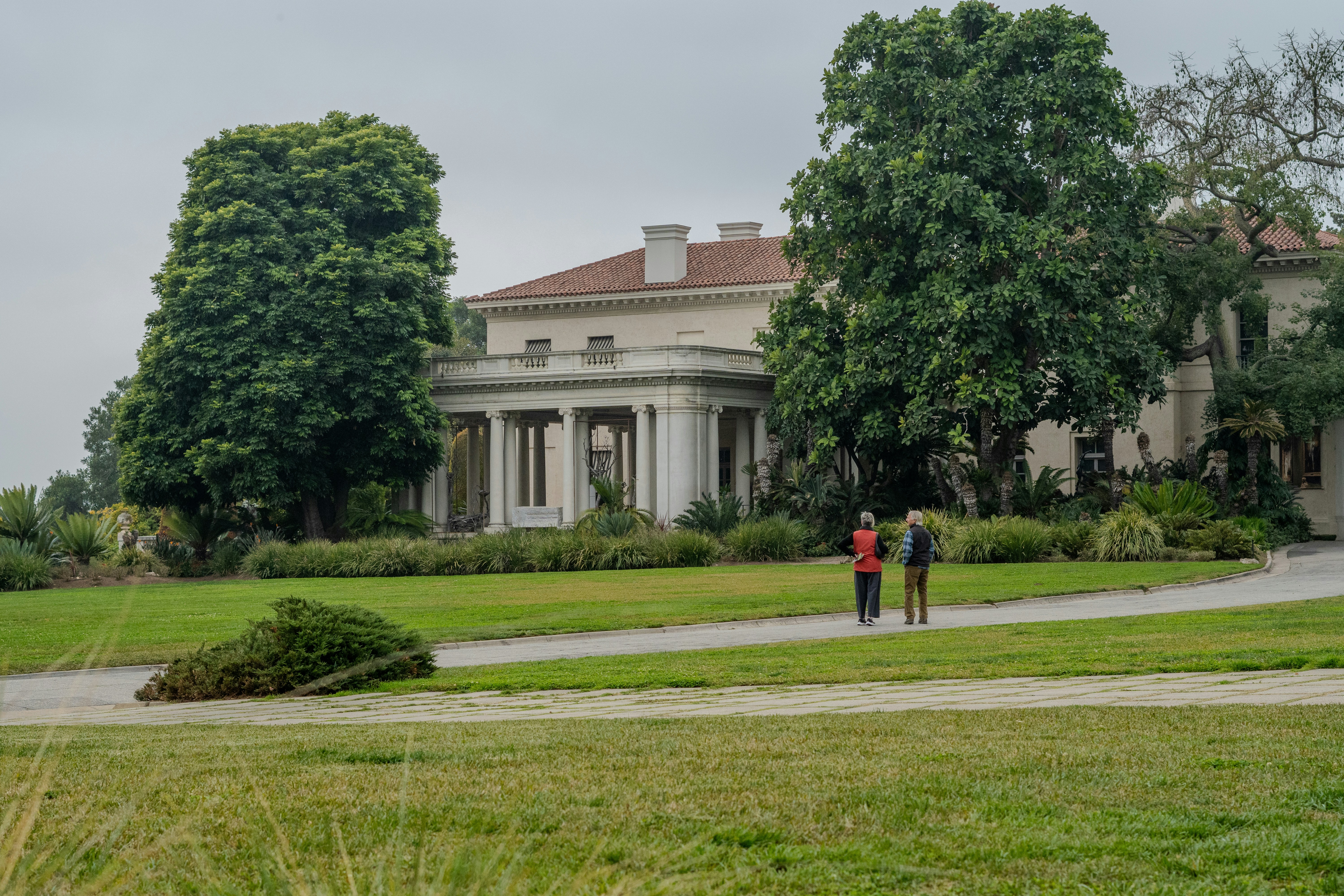 a couple of people that are standing in the grass