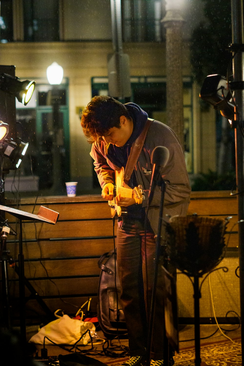 a man standing next to a microphone on a stage