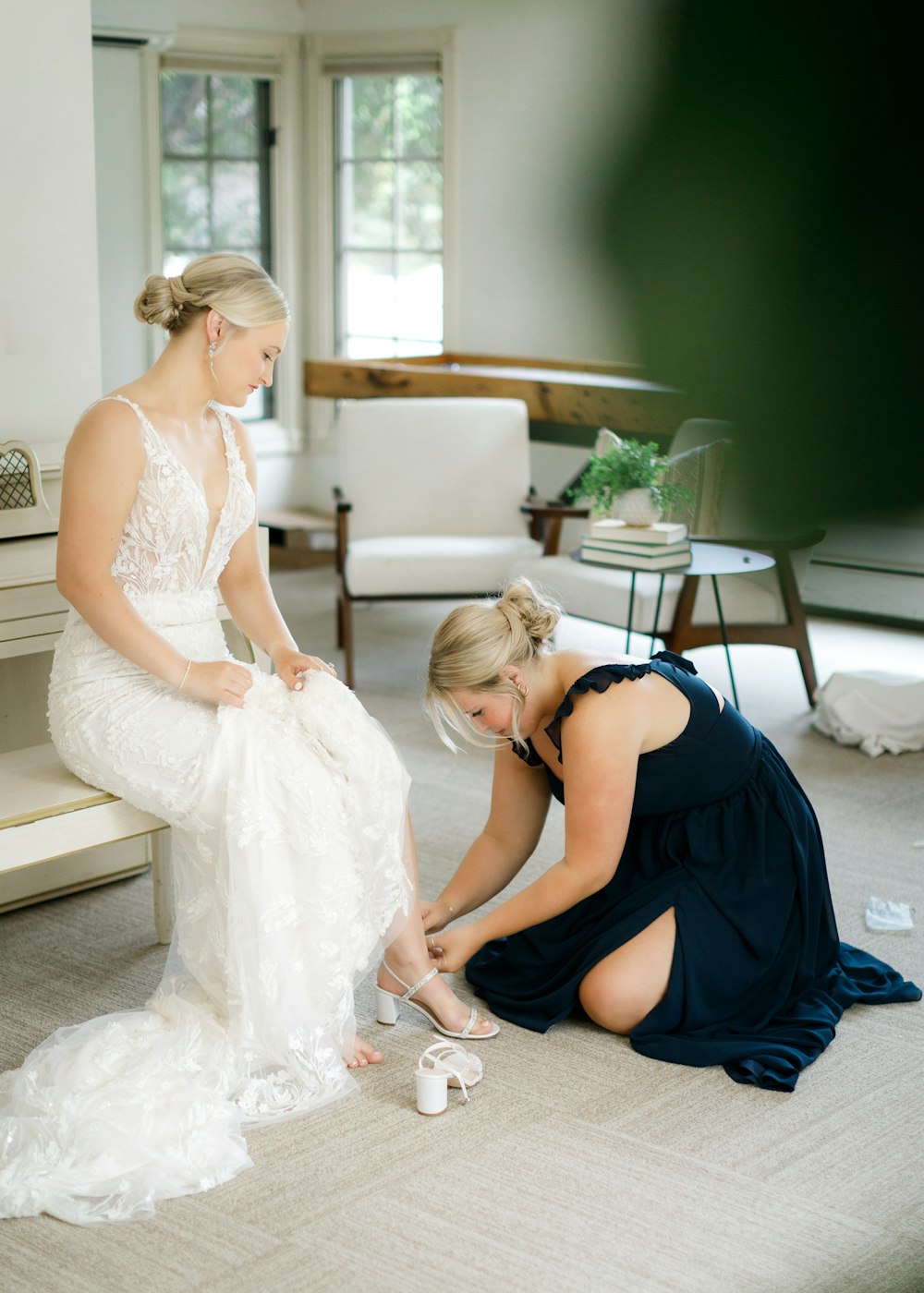 a bride and her bridesmaids putting on shoes