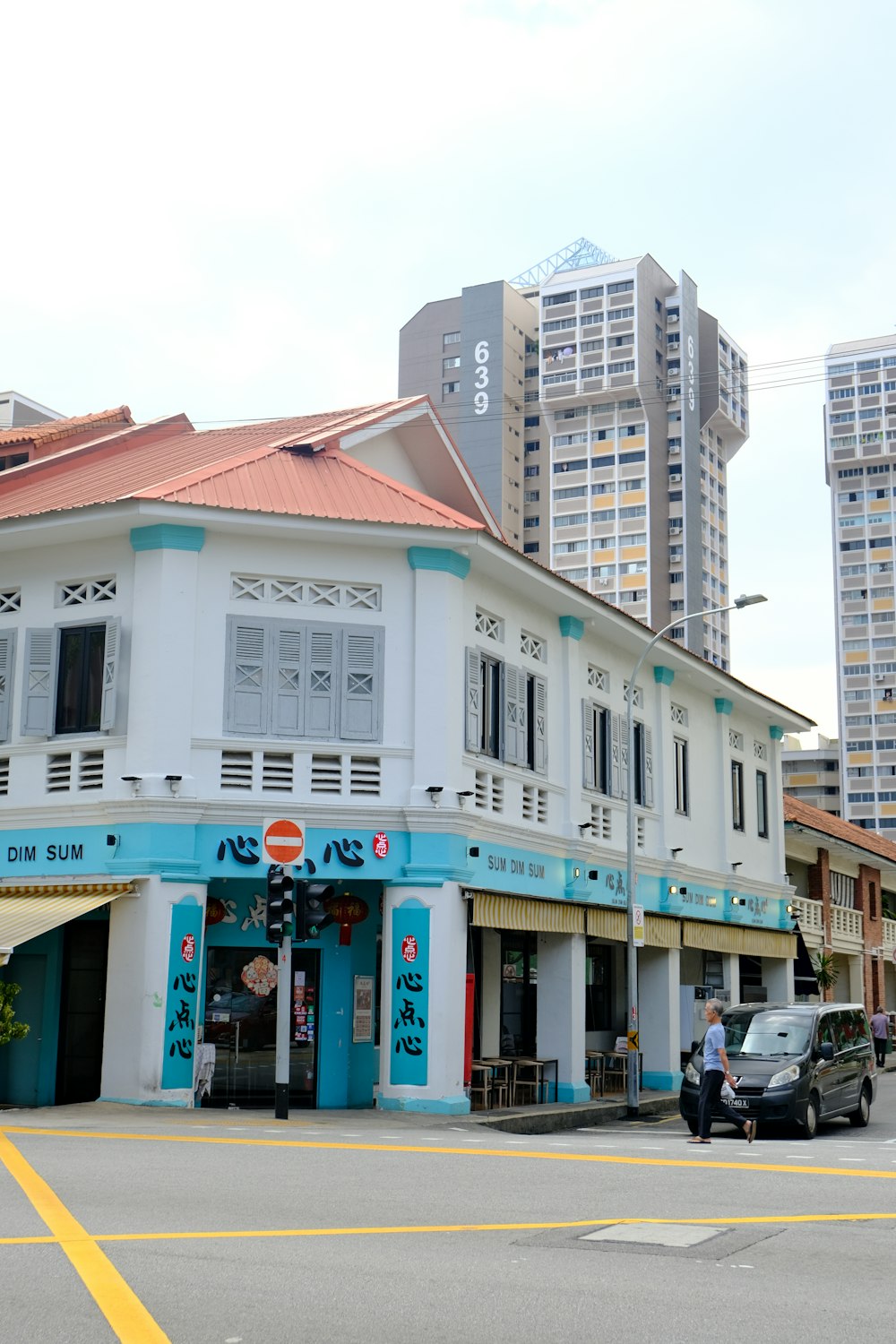 a white building with blue trim and a red roof