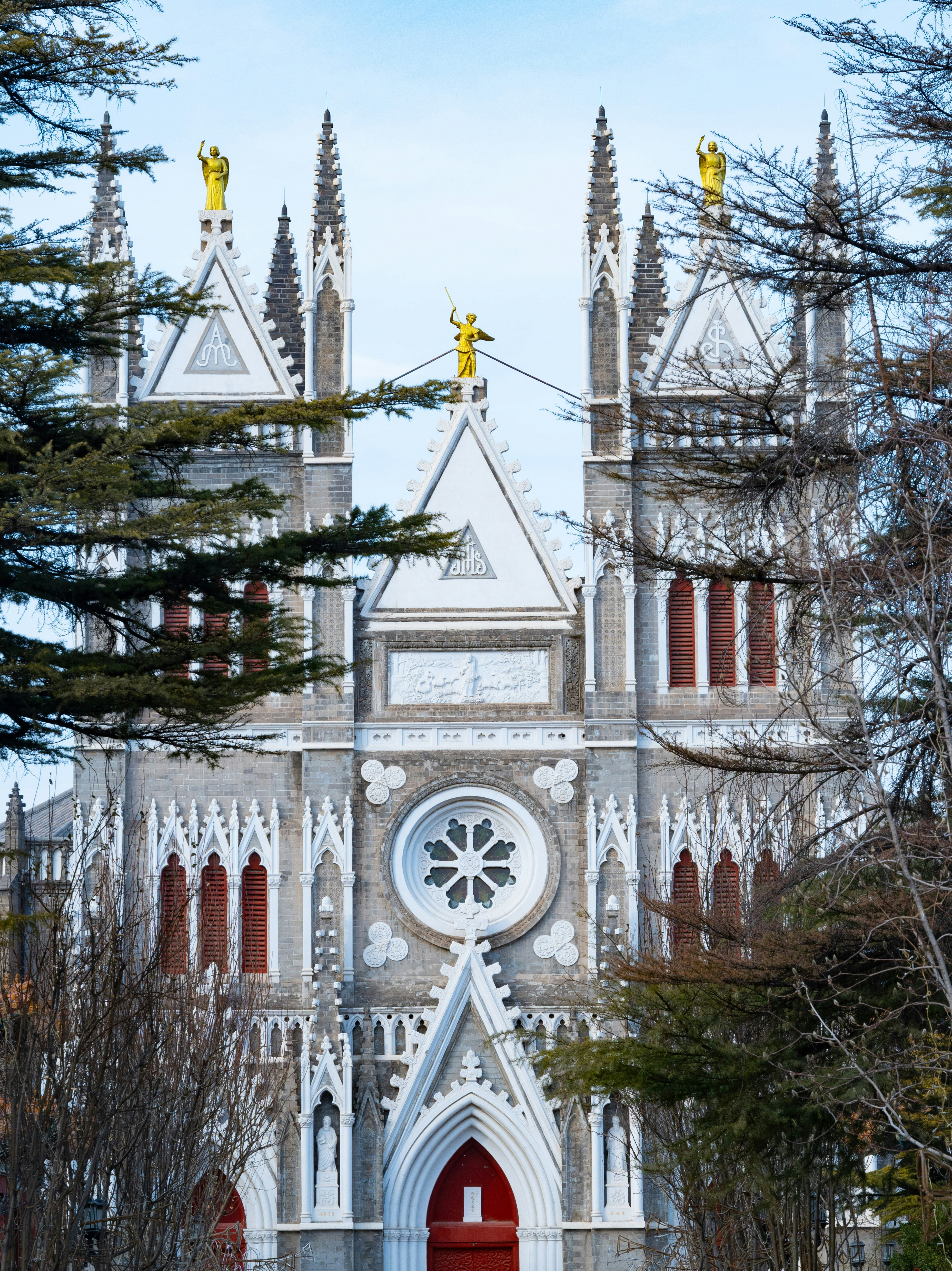 a church with a red door and a tall tower