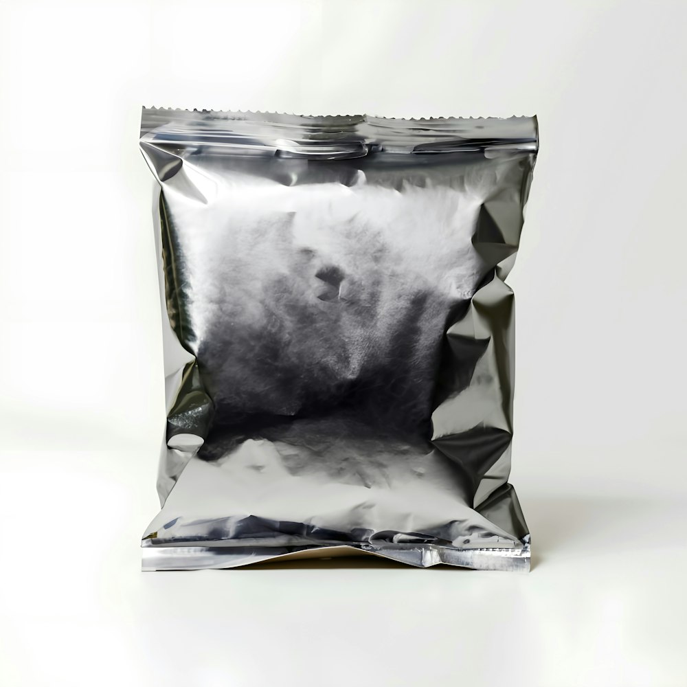 a bag of silver foil sitting on top of a white table