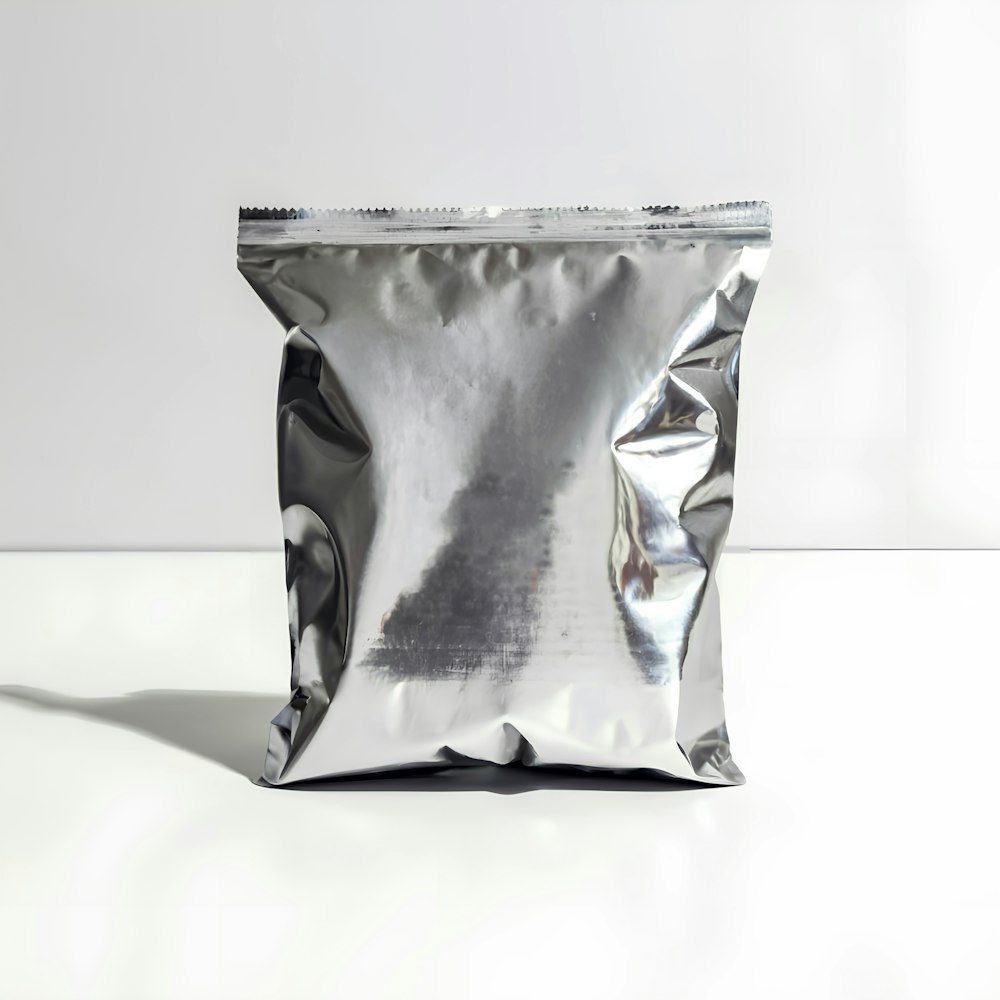 a silver foil bag sitting on a white surface