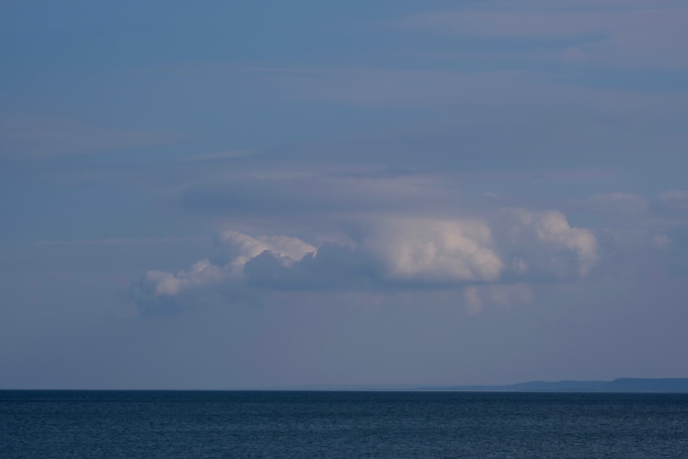 a large body of water under a cloudy sky