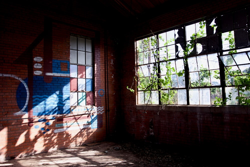 a room with a brick wall and a large window