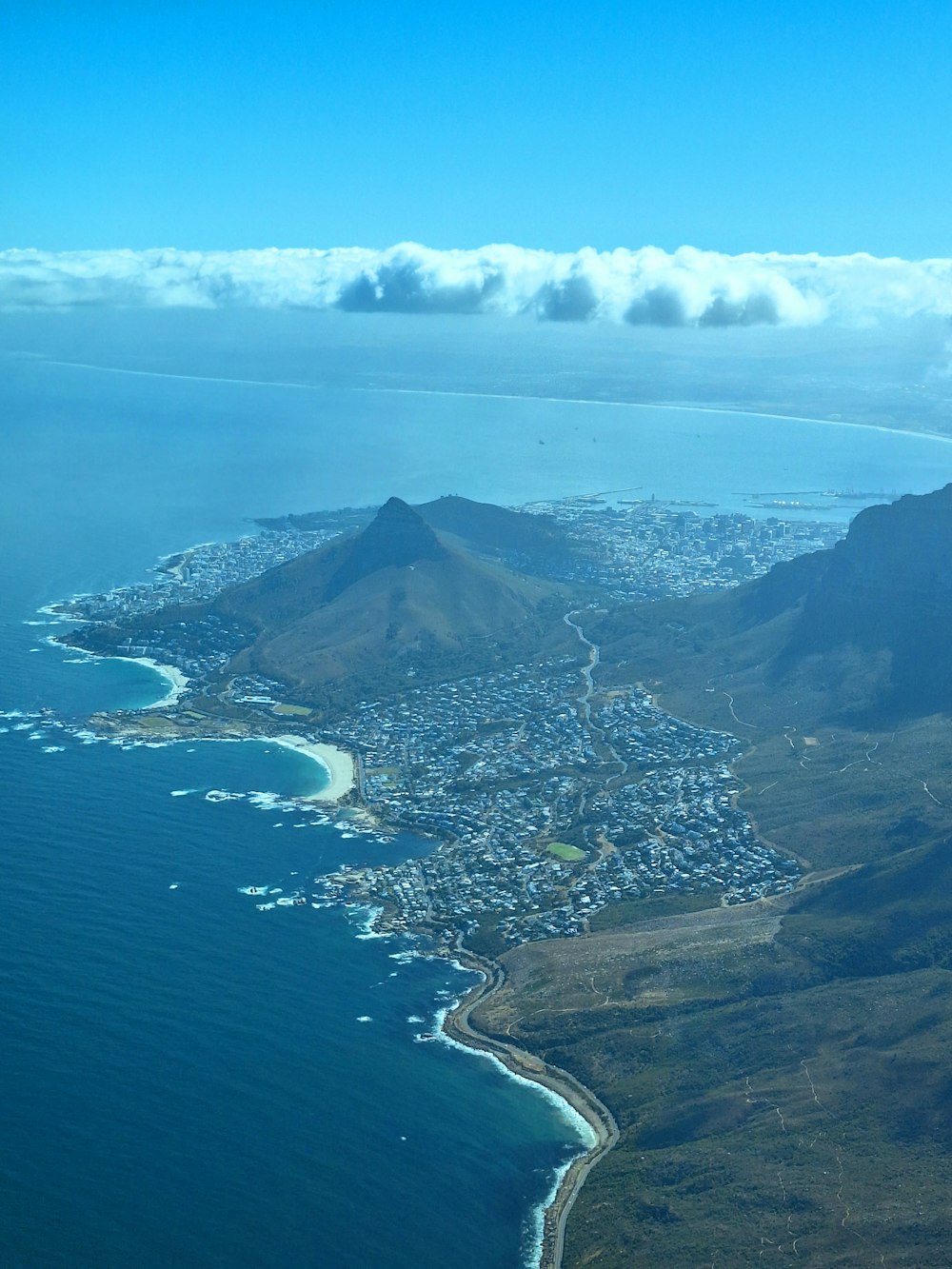 an aerial view of a city and the ocean