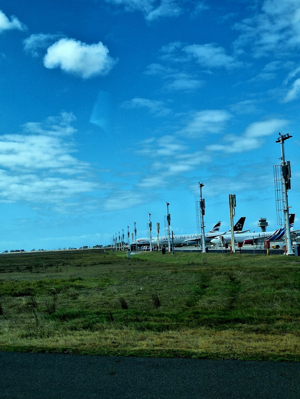 a grassy field with a bunch of airplanes parked on top of it