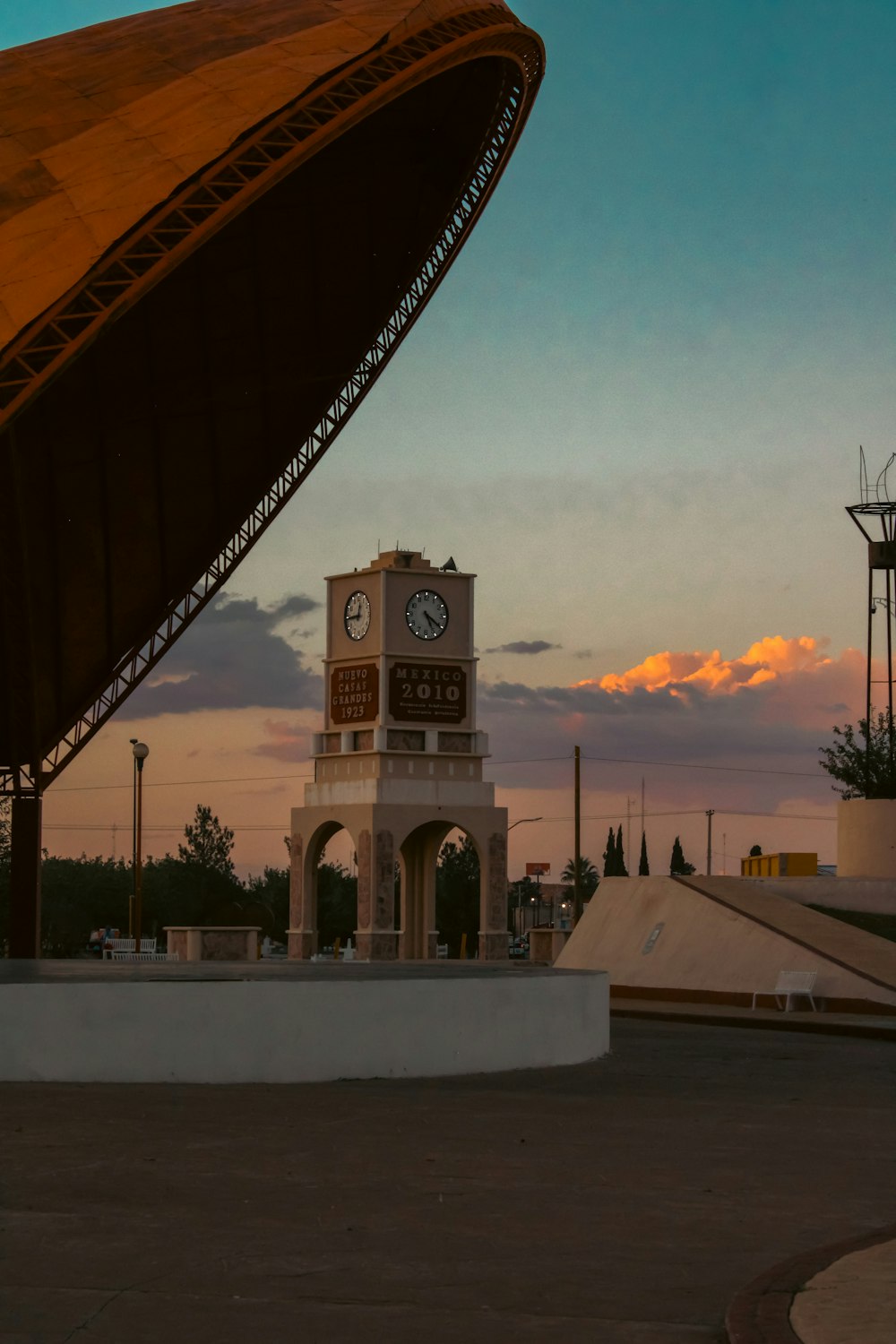 a clock tower in the middle of a parking lot