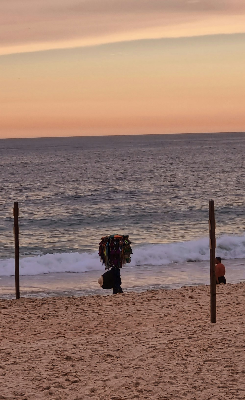 a person walking on a beach with a surfboard