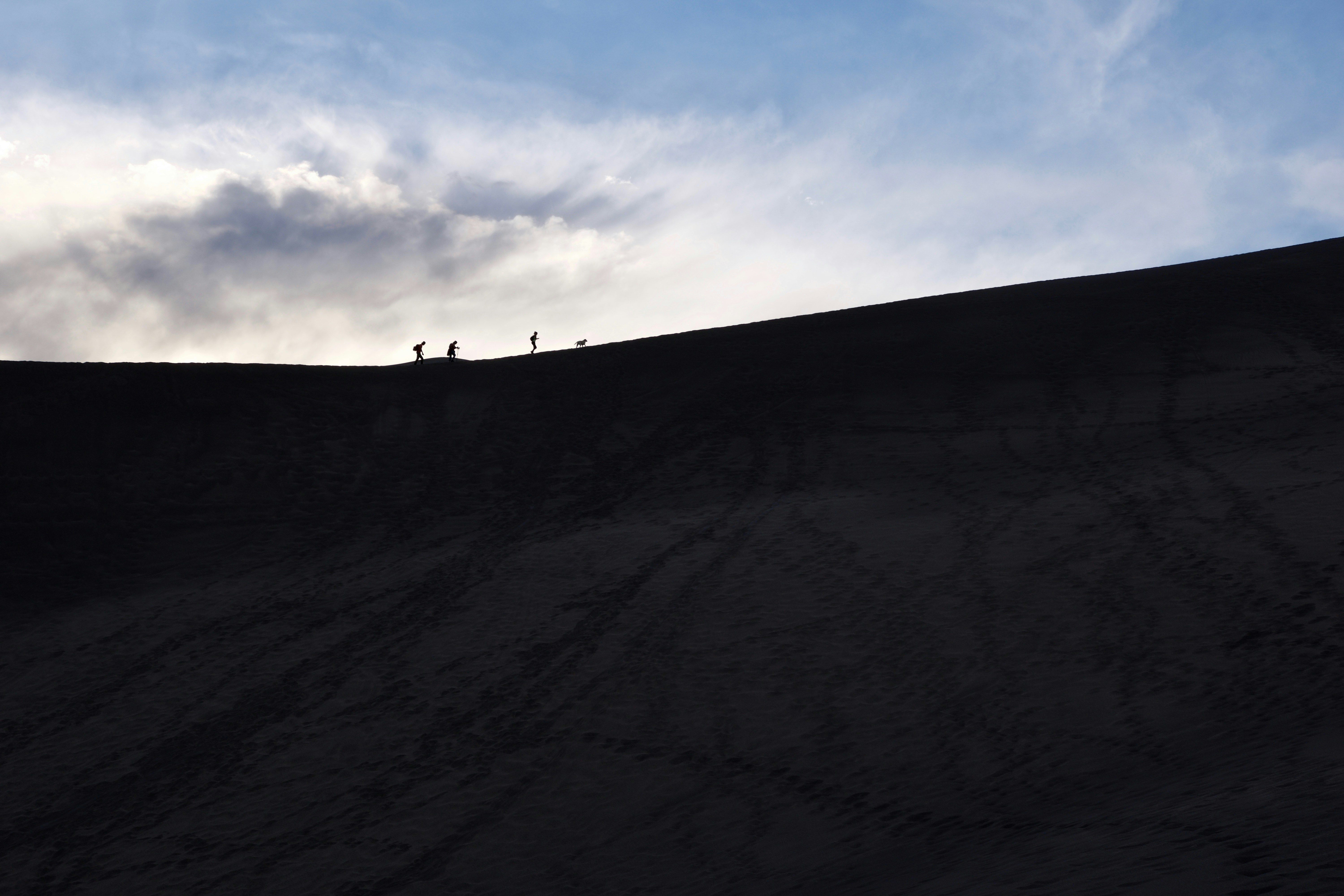 a group of people riding skis down a snow covered slope
