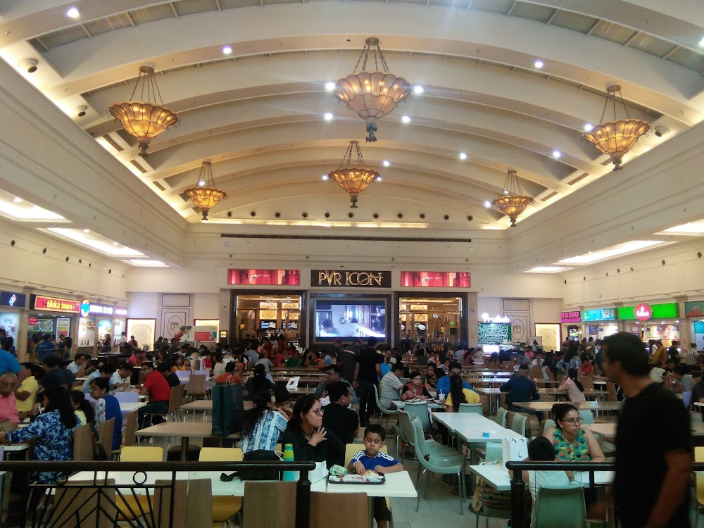 a large group of people sitting at tables in a restaurant