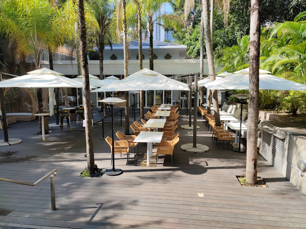 a group of tables with umbrellas on a deck