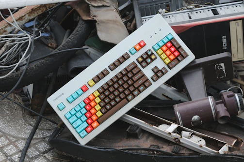 a computer keyboard sitting on top of a pile of junk