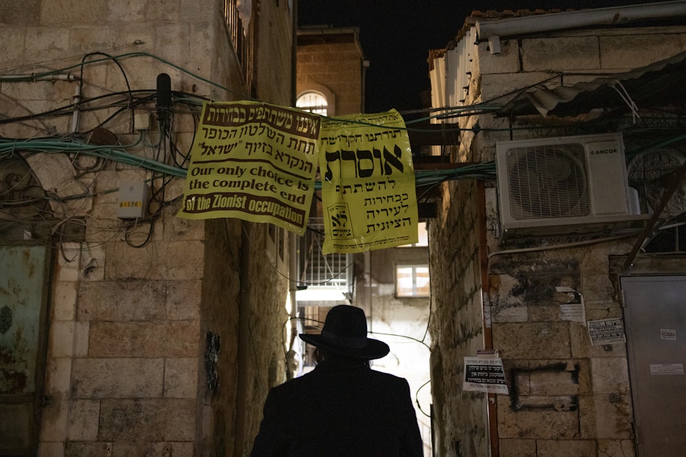 a man walking down a narrow alley way