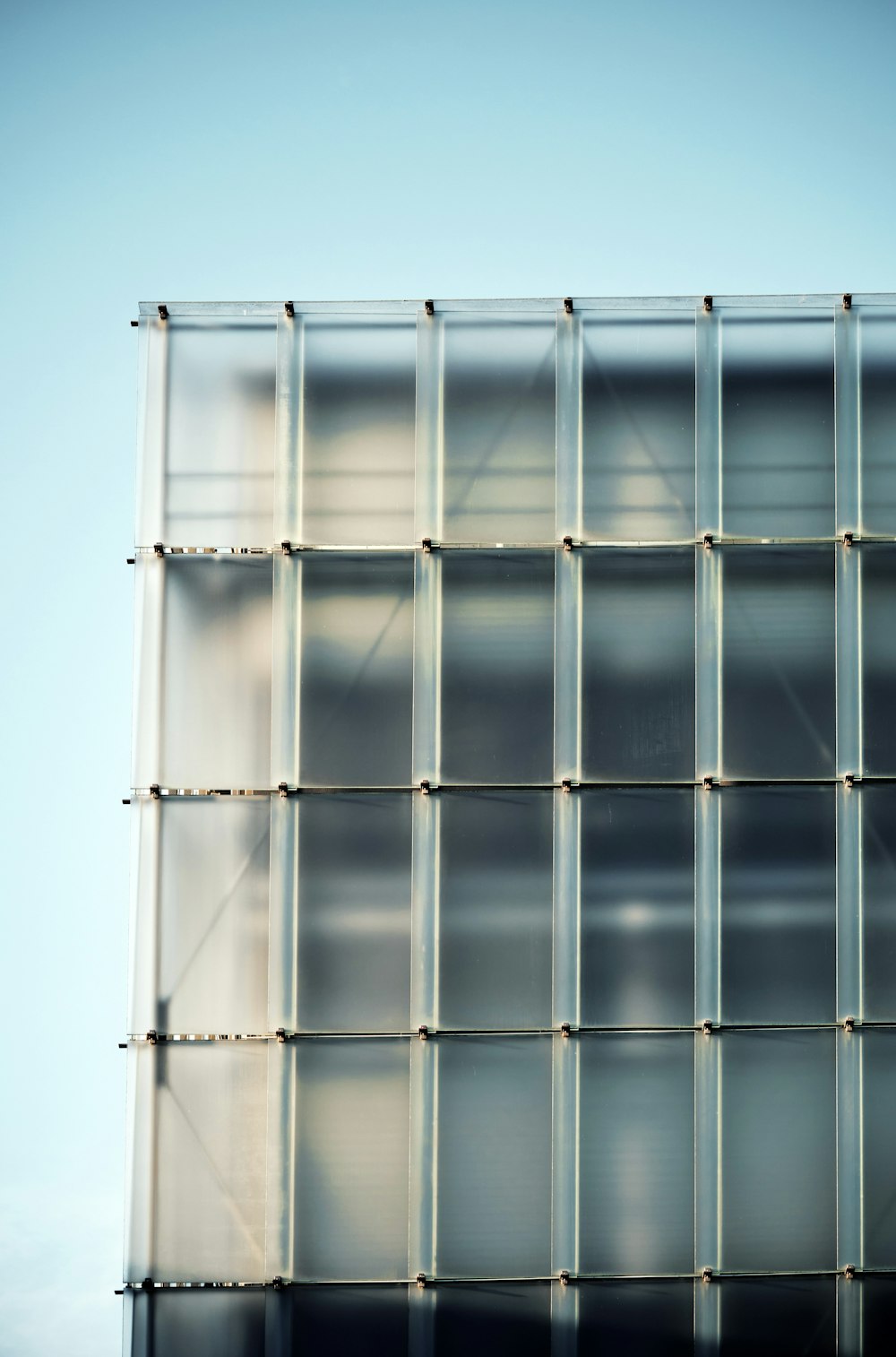 a tall glass building with lots of windows