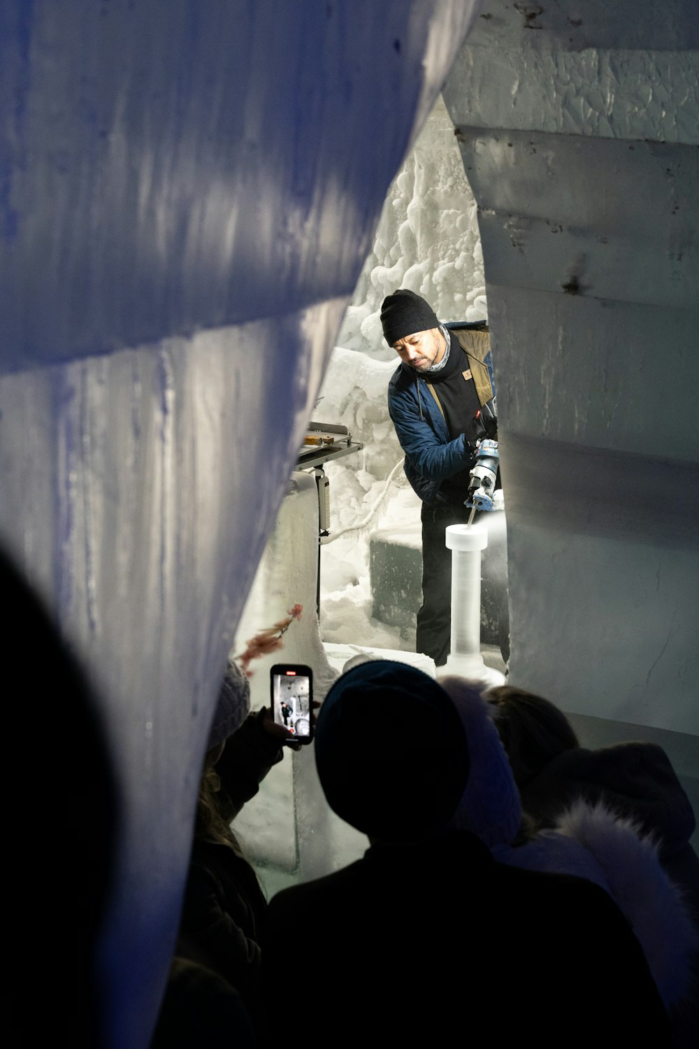 a man taking a picture of himself in an ice cave