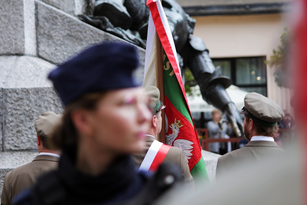 a group of people standing next to a statue