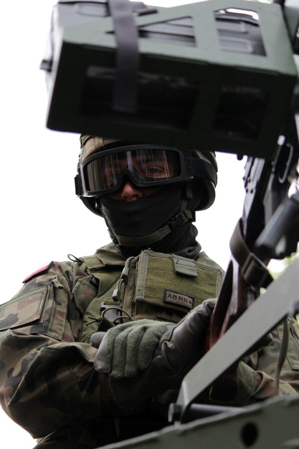 a man in camouflage holding a machine gun