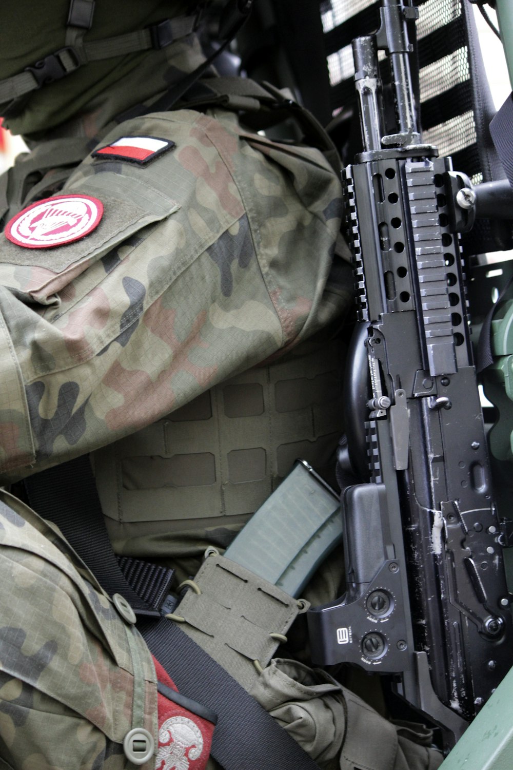 a close up of a military uniform with a machine gun