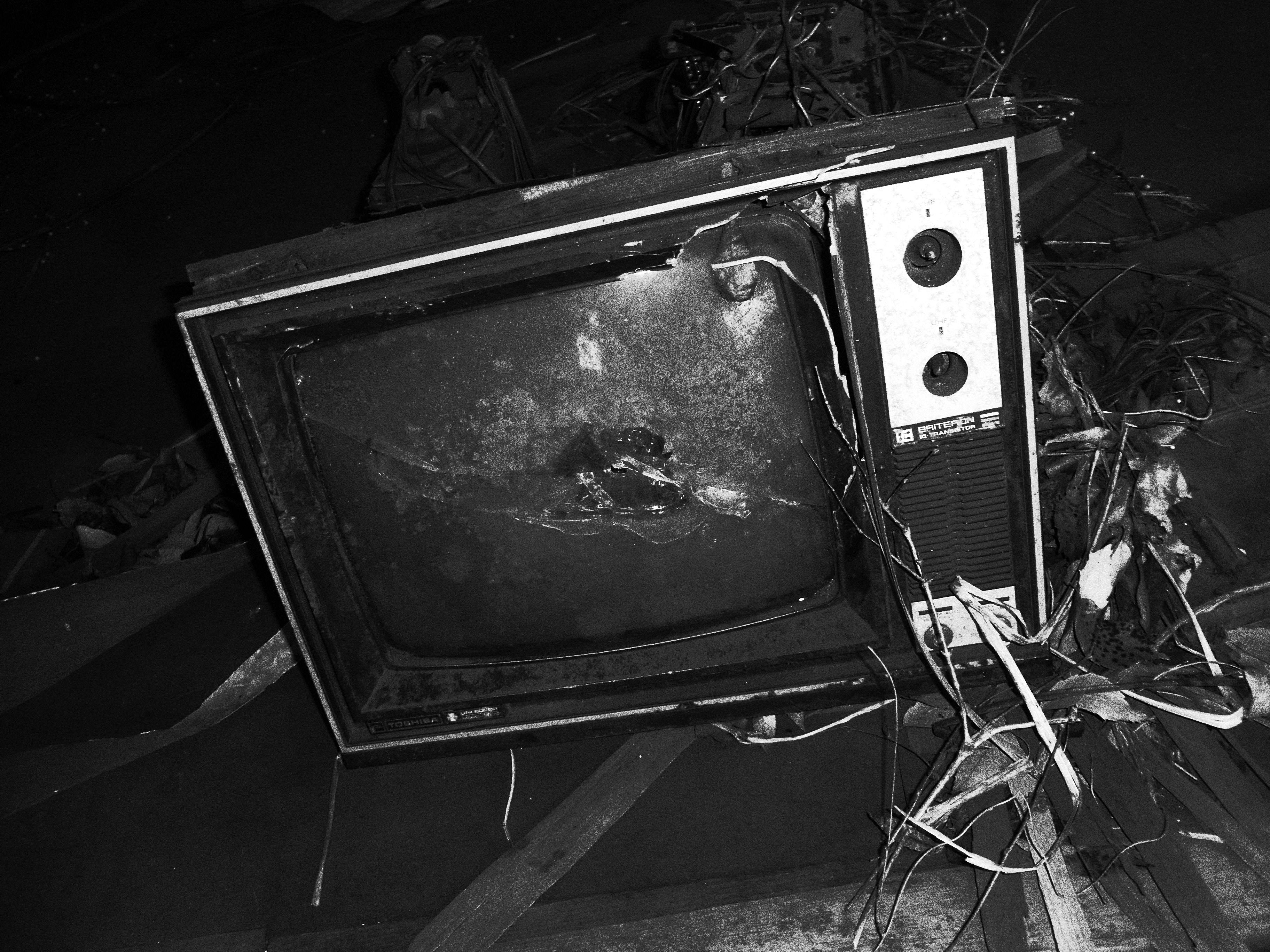 An old tv sitting on top of a pile of debris photo Free Tv Image on